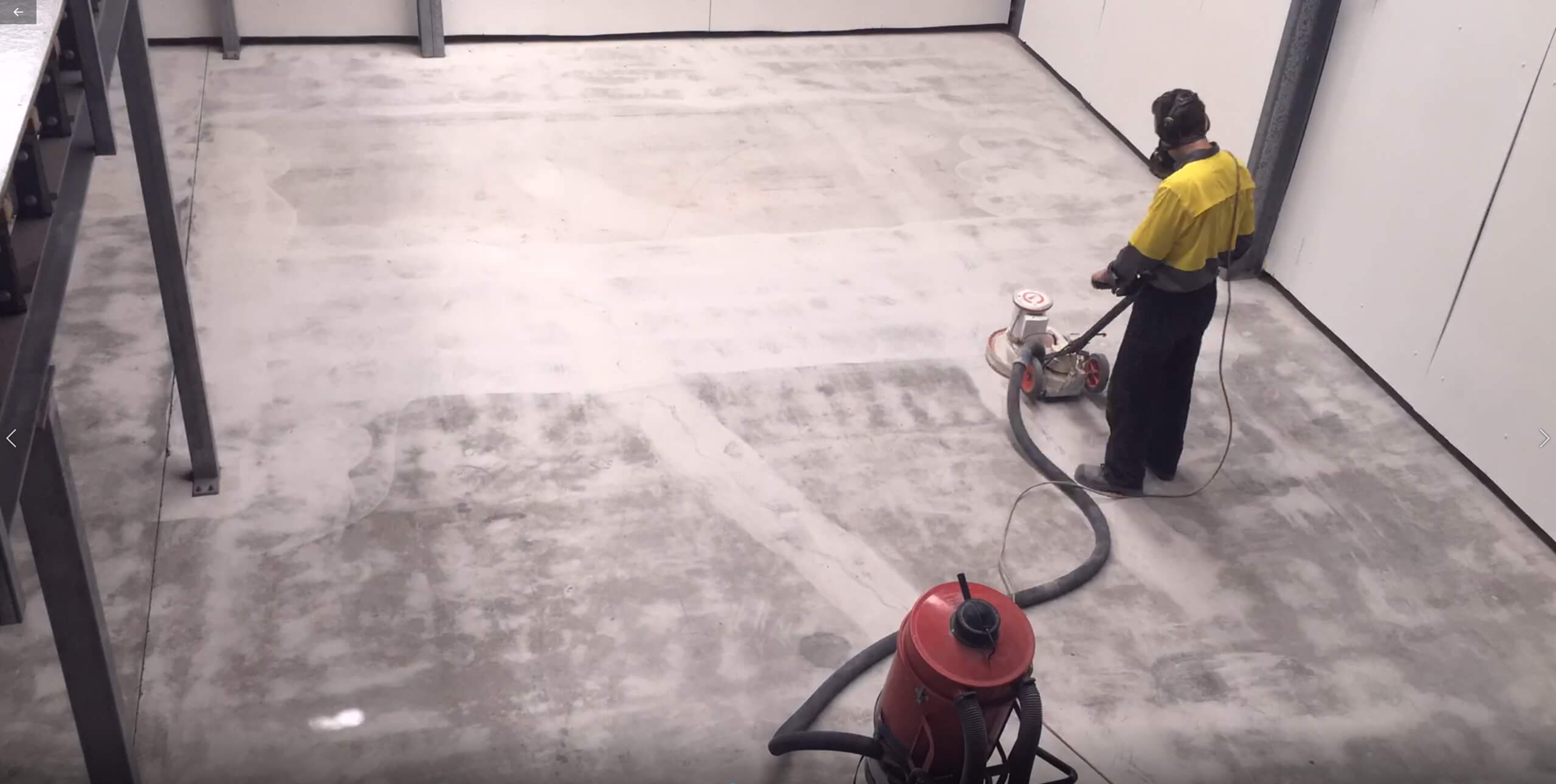 The Diamabrush Coating Removal Tool being used to prepare concrete in an industrial shed.